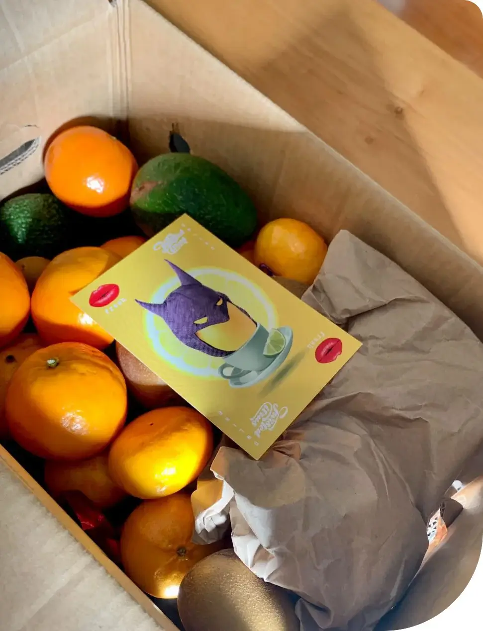 Open box of a variety of fruit with a leaflet on top