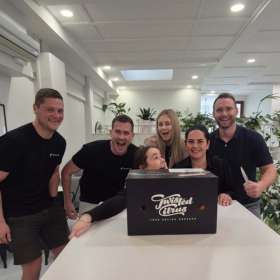 Gloved hand putting an orange sticker on a black box